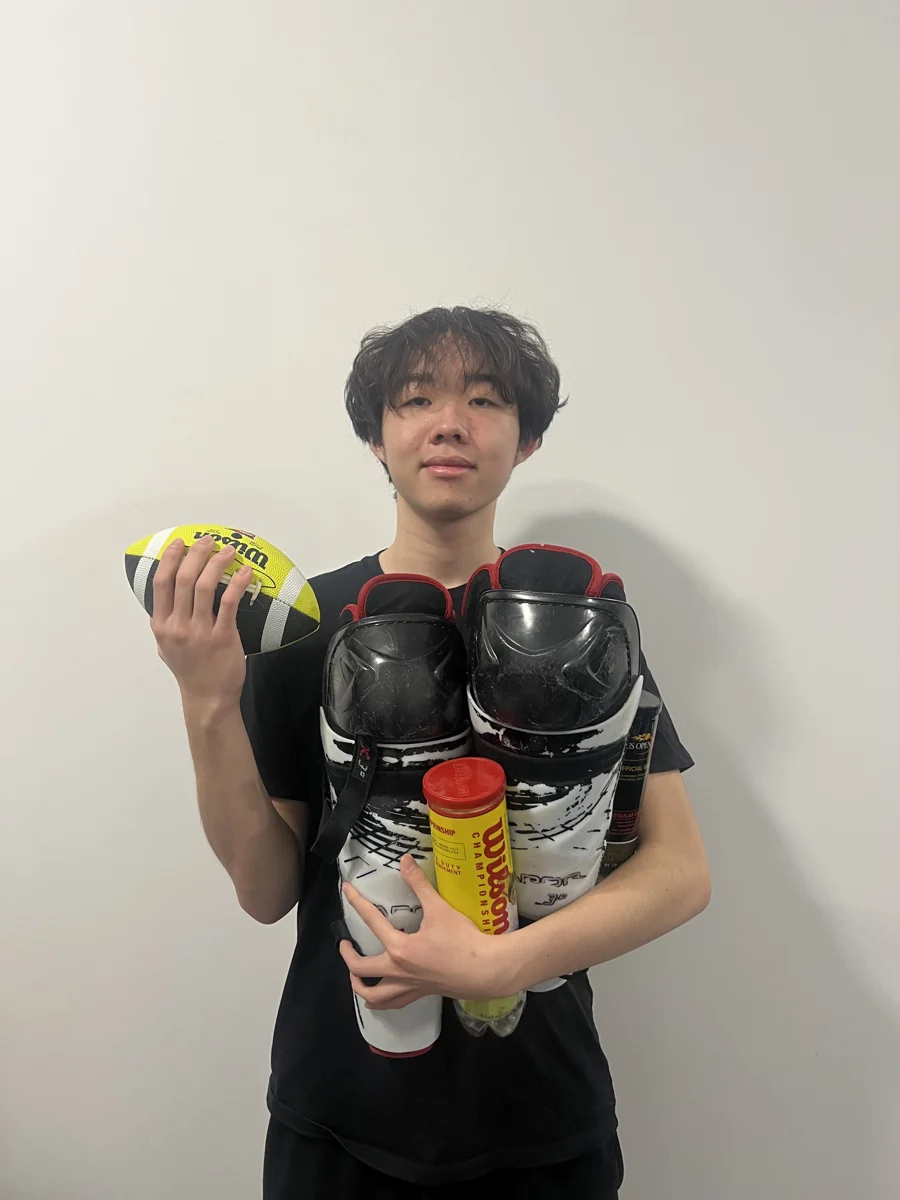 A donor holding sports equipment collected through TFS